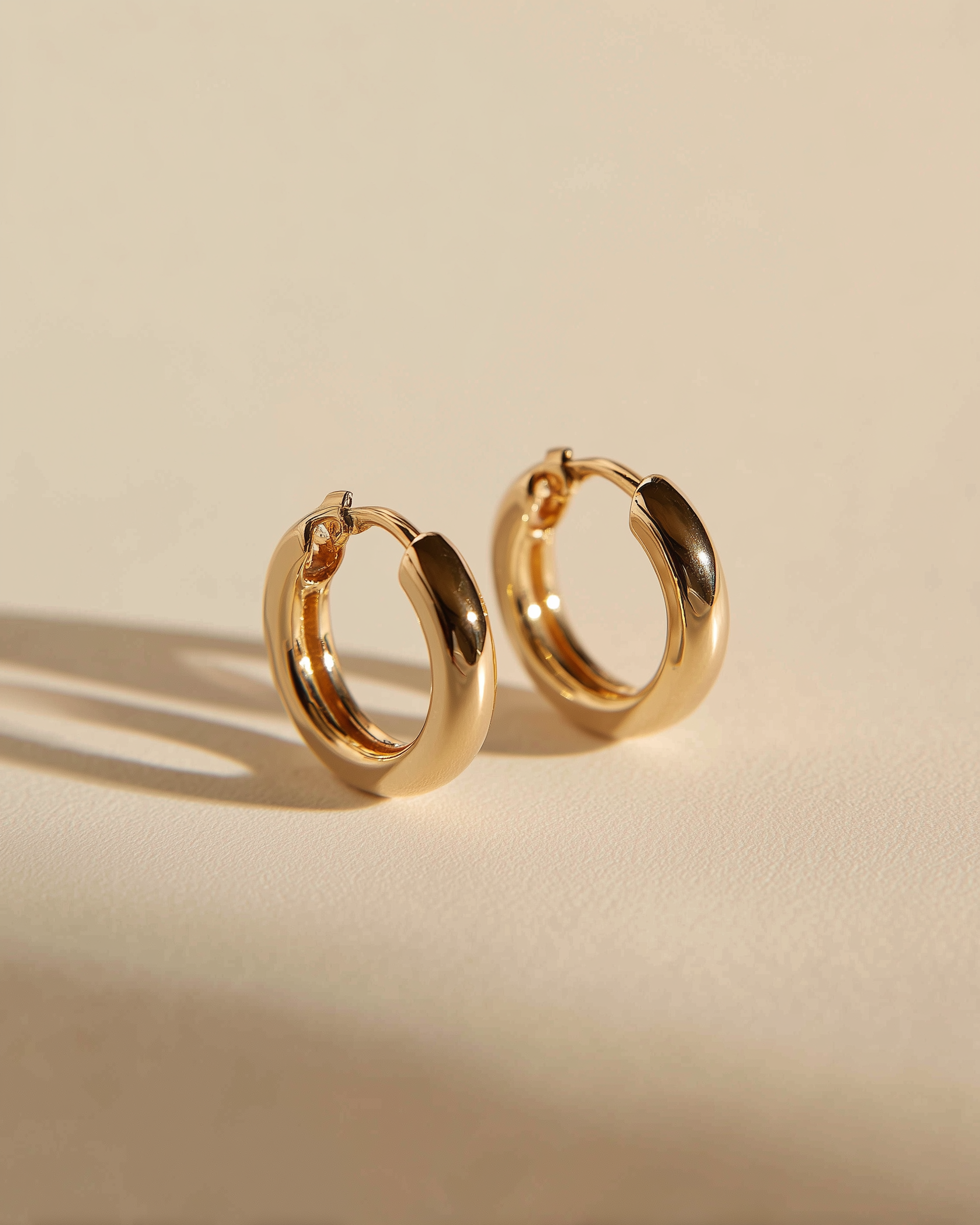 14k gold-fill huggie earrings on cream silk